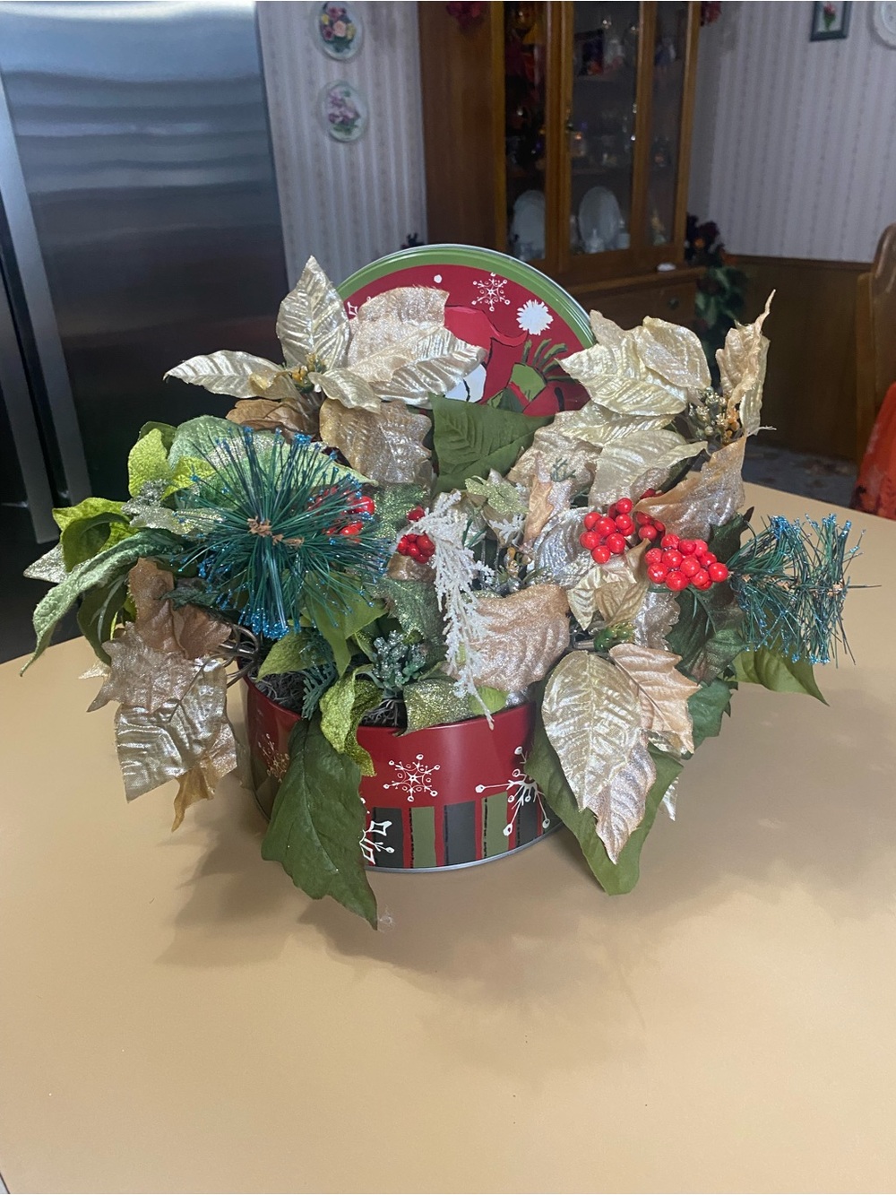 Holiday Tin Floral Arrangement with Gold Poinsettias and Red Berries